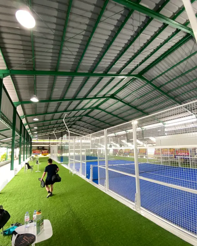 Turf walkway beside the blue courts