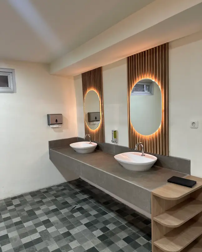 Restroom with backlit mirrors